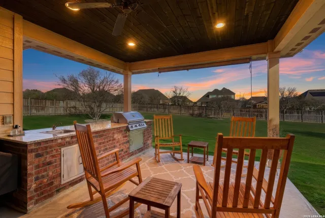 a view of a house with a backyard porch and sitting area