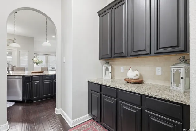 a kitchen with granite countertop stainless steel appliances and cabinets
