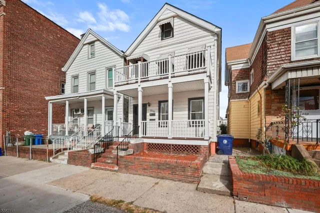 a front view of a house with outdoor seating