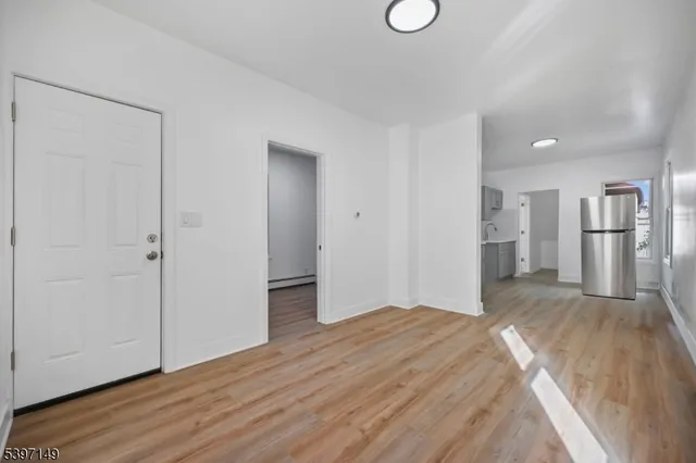 a view of a kitchen with wooden floor and a sink