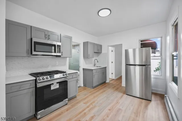 a kitchen with stainless steel appliances a refrigerator stove and microwave