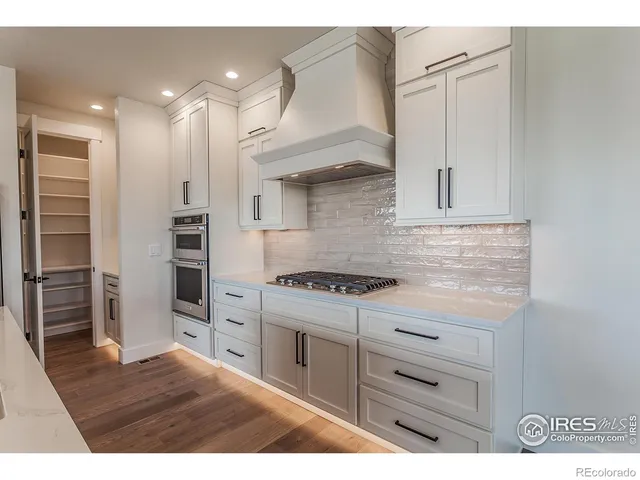 a kitchen with cabinets appliances and a counter space