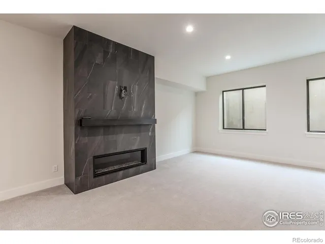 a view of an empty room with wooden floor and cabinet