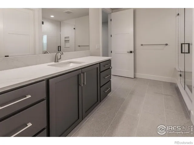a bathroom with a double vanity sink a and mirror