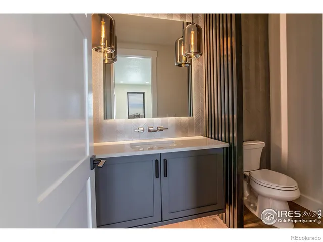 a bathroom with a sink toilet and mirror