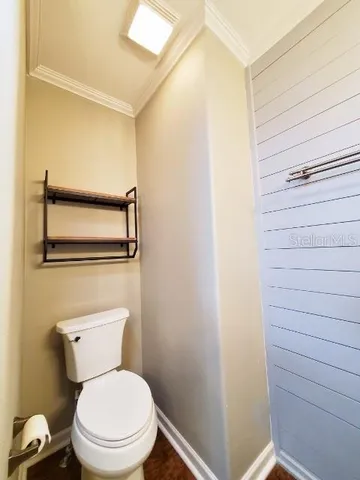 a white toilet sitting next to a shower