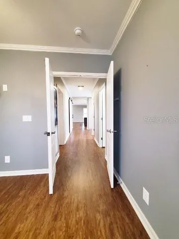 a view of a hallway with wooden floor