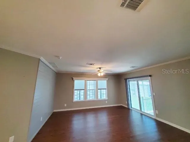 wooden floor in an empty room with a window
