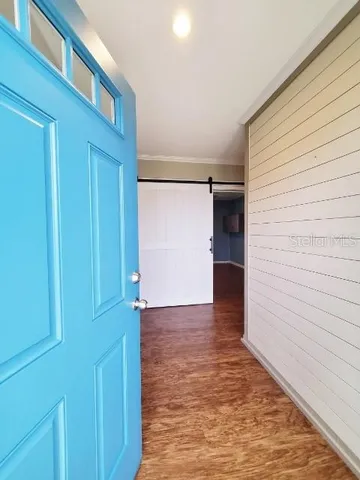 a view of hallway with wooden floor