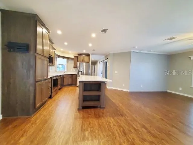 a view of kitchen and kitchen with a sink