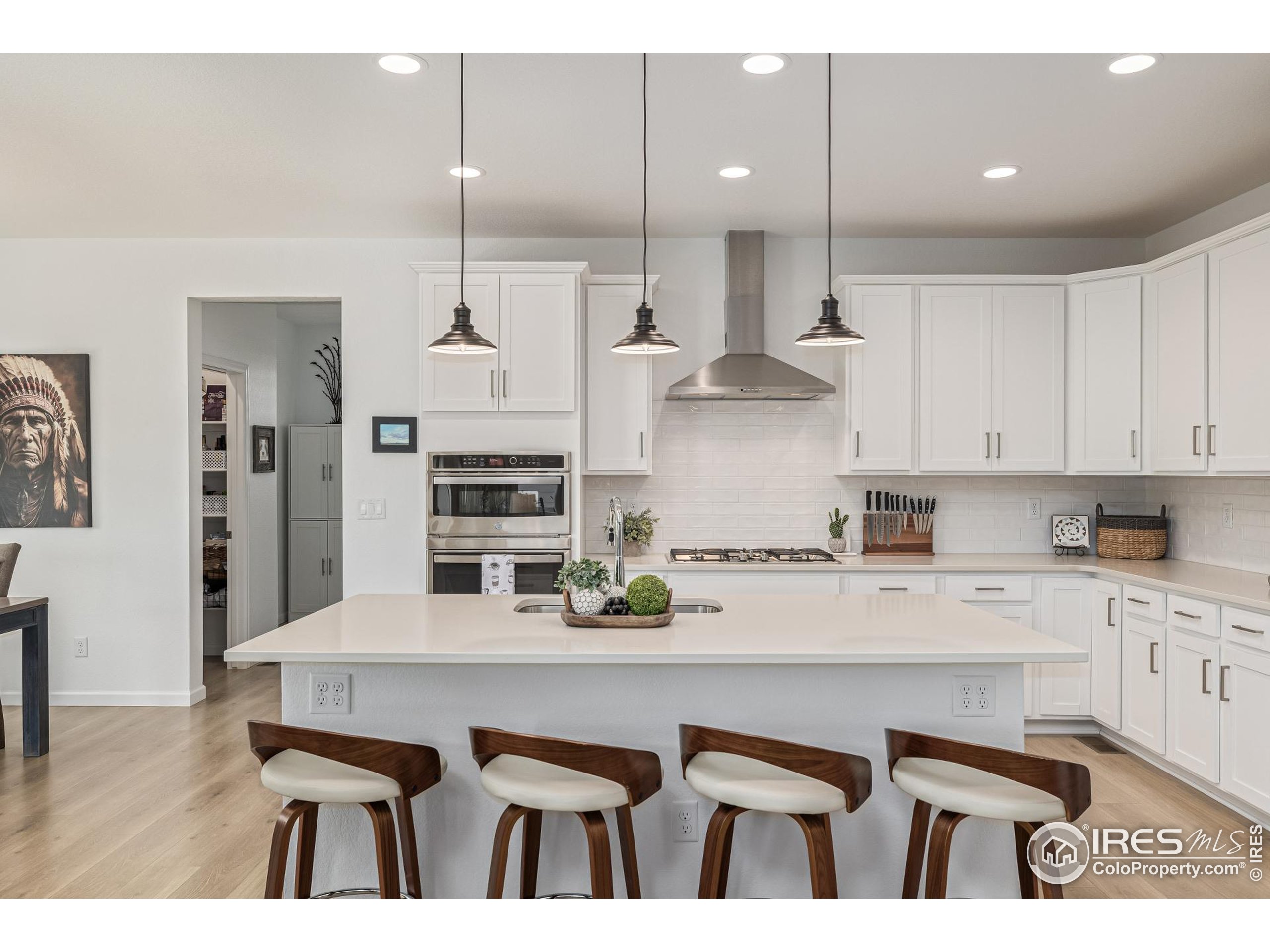 3624 Rucksack Court Castle Rock, CO 80108 - Photo 19 of 50 a kitchen with kitchen island a stove a table and chairs in it