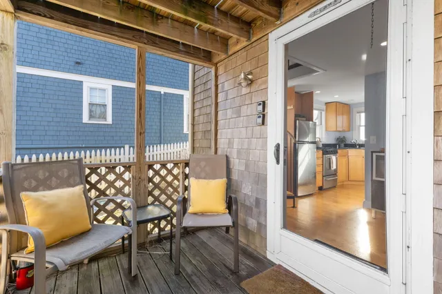 a balcony with furniture and wooden floor