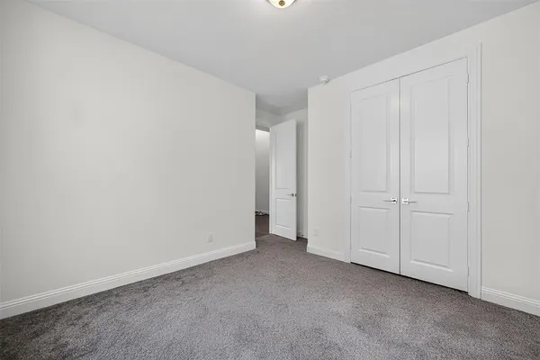 a view of an empty room and closet area