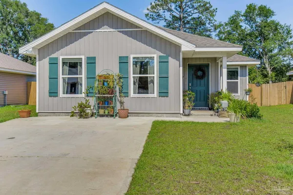 a front view of a house with a yard and porch