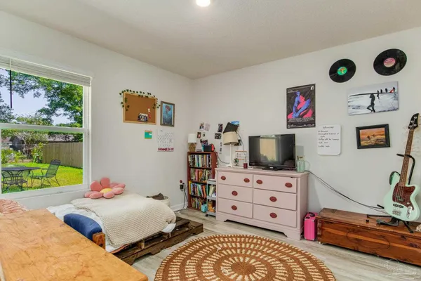 a bedroom with a bed and painting on the wall