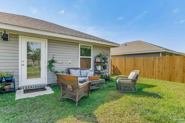 a view of a house with backyard sitting area and garden