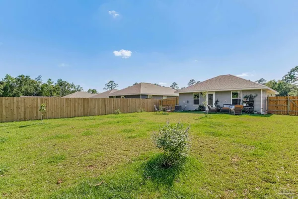 a view of backyard with outdoor seating and green space