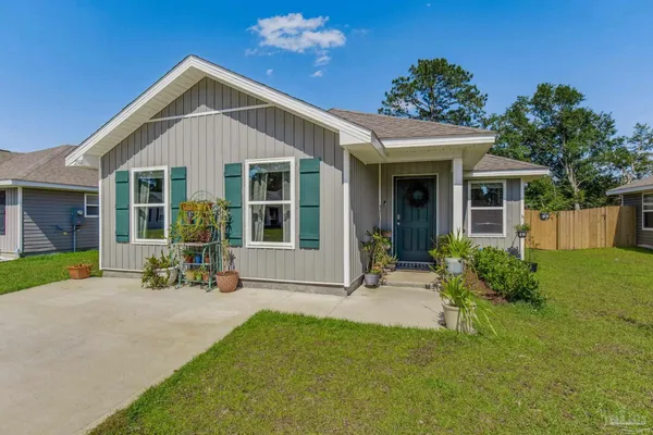 a front view of a house with a garden and porch