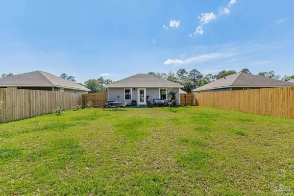 a view of a house with a backyard
