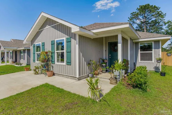 a front view of a house with a yard outdoor seating and garden