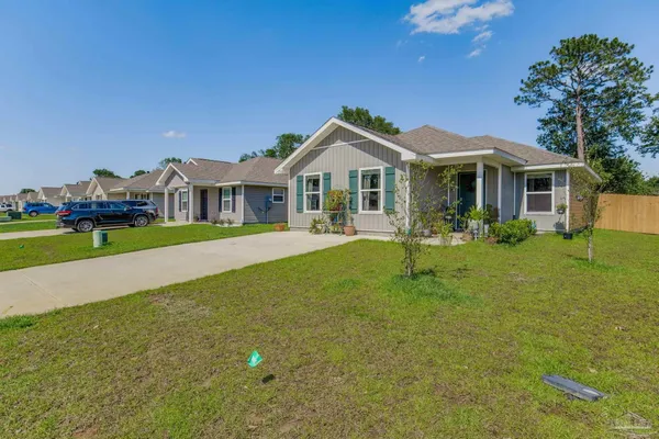 a front view of a house with garden