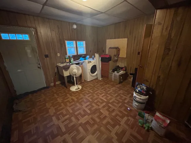 a room with furniture a rug and white walls