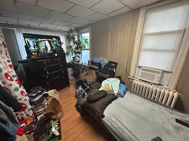 a bedroom with furniture and a flat screen tv