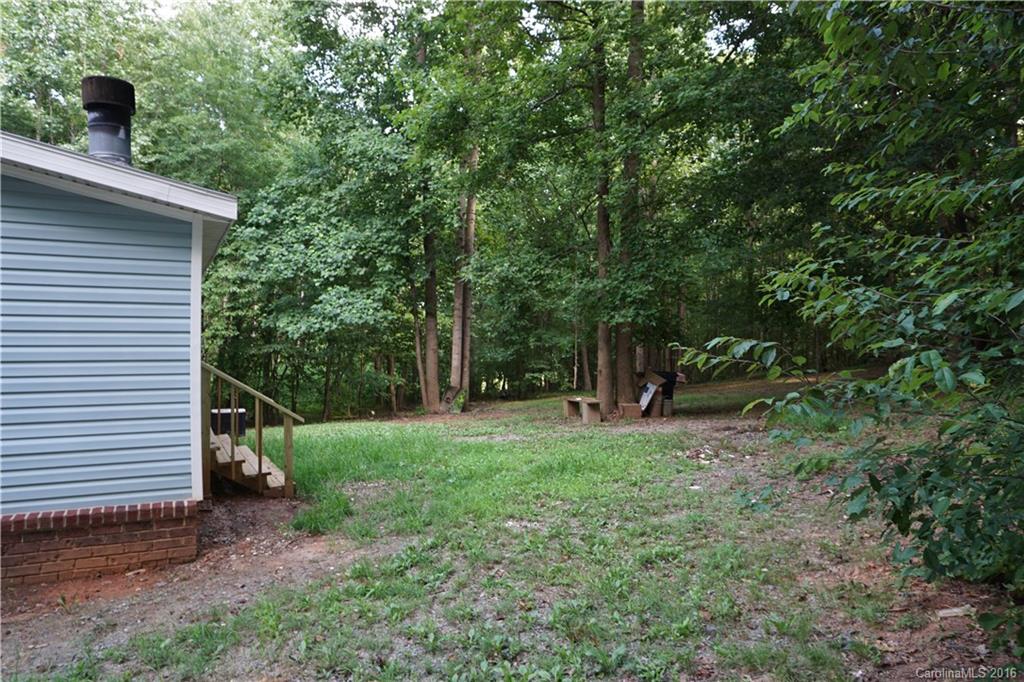 7385 Tuckaseegee Road Kannapolis, NC 28081 - Photo 12 of 14 a backyard of a house with lots of green space