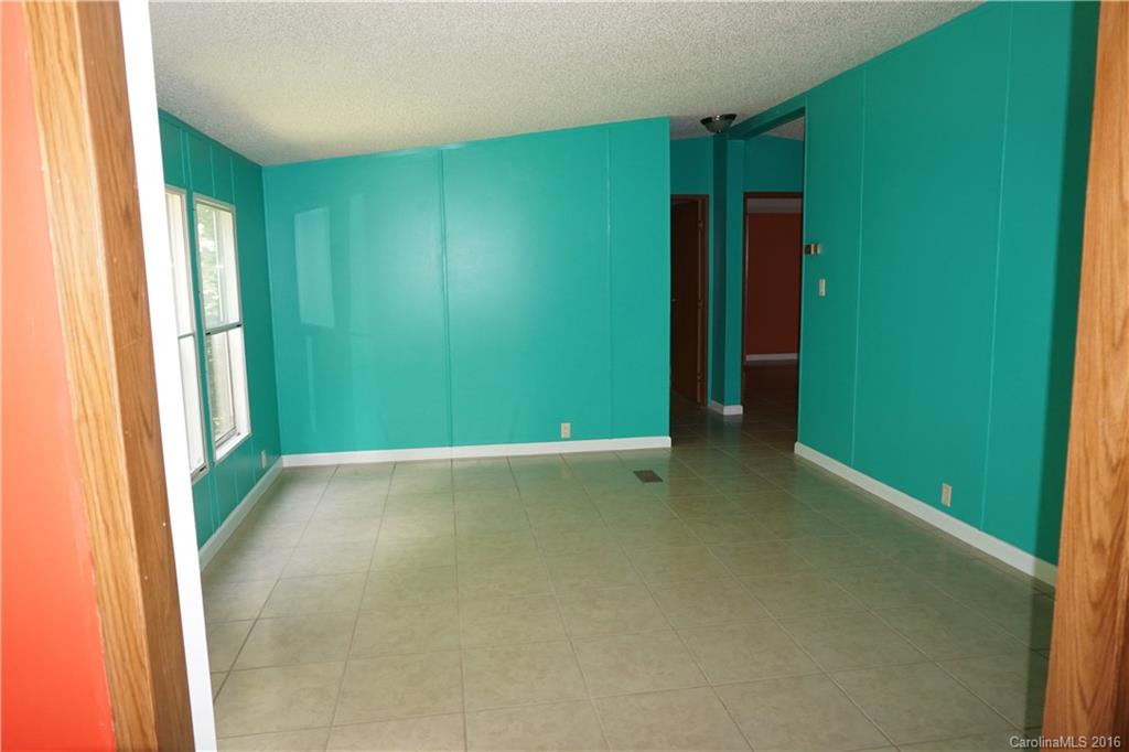 7385 Tuckaseegee Road Kannapolis, NC 28081 - Photo 5 of 14 a view of an empty room with window and stairs