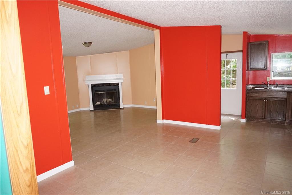7385 Tuckaseegee Road Kannapolis, NC 28081 - Photo 6 of 14 a view of a livingroom with furniture and a fireplace