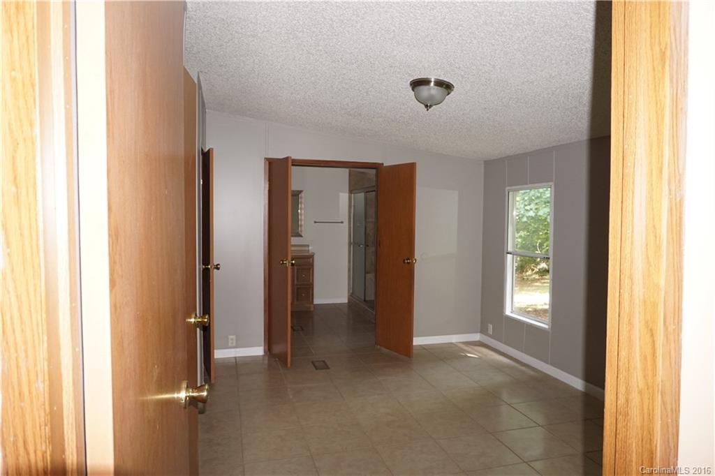 7385 Tuckaseegee Road Kannapolis, NC 28081 - Photo 7 of 14 a view of an empty room with a window