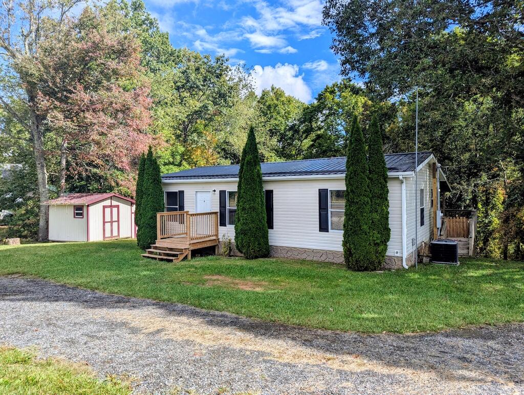 3335 Daniels Run Road Northeast Check, VA 24072 - Photo 1 of 23 a front view of a house with a yard and garage