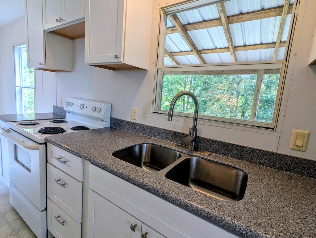 3335 Daniels Run Road Northeast Check, VA 24072 - Photo 12 of 23 a kitchen with granite countertop a sink and a window