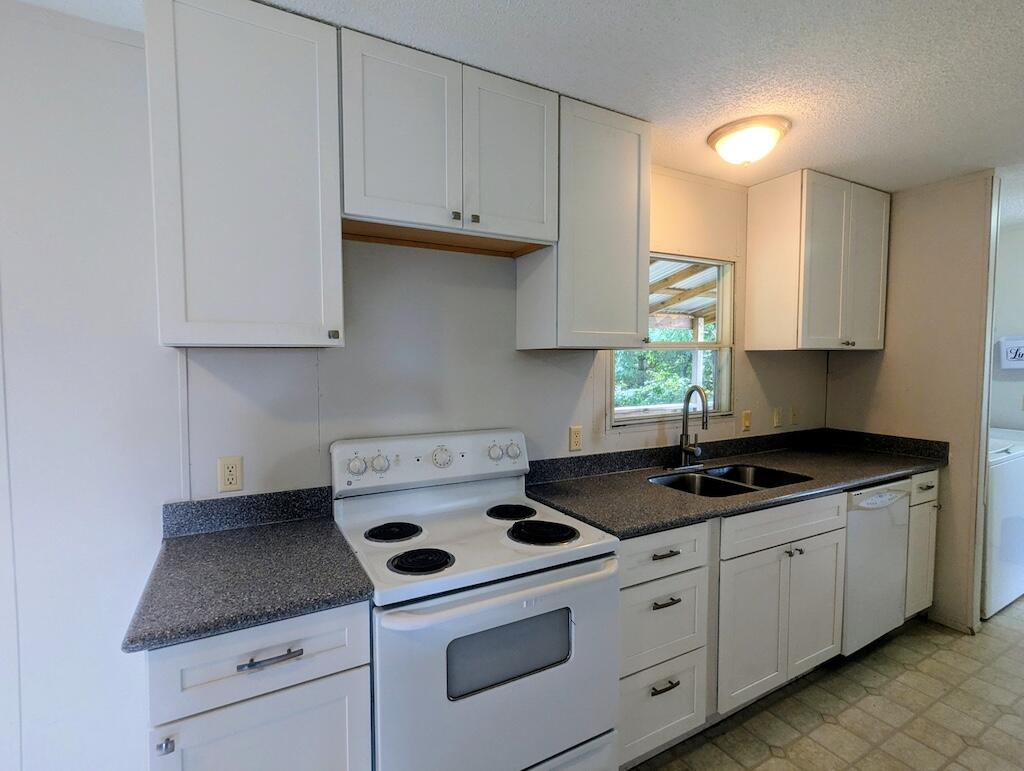 3335 Daniels Run Road Northeast Check, VA 24072 - Photo 14 of 23 a kitchen with granite countertop white cabinets and white stove