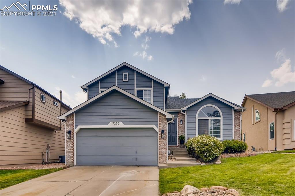 7330 Julynn Road Colorado Springs, CO 80919 - Photo 2 of 28 a front view of a house with a yard