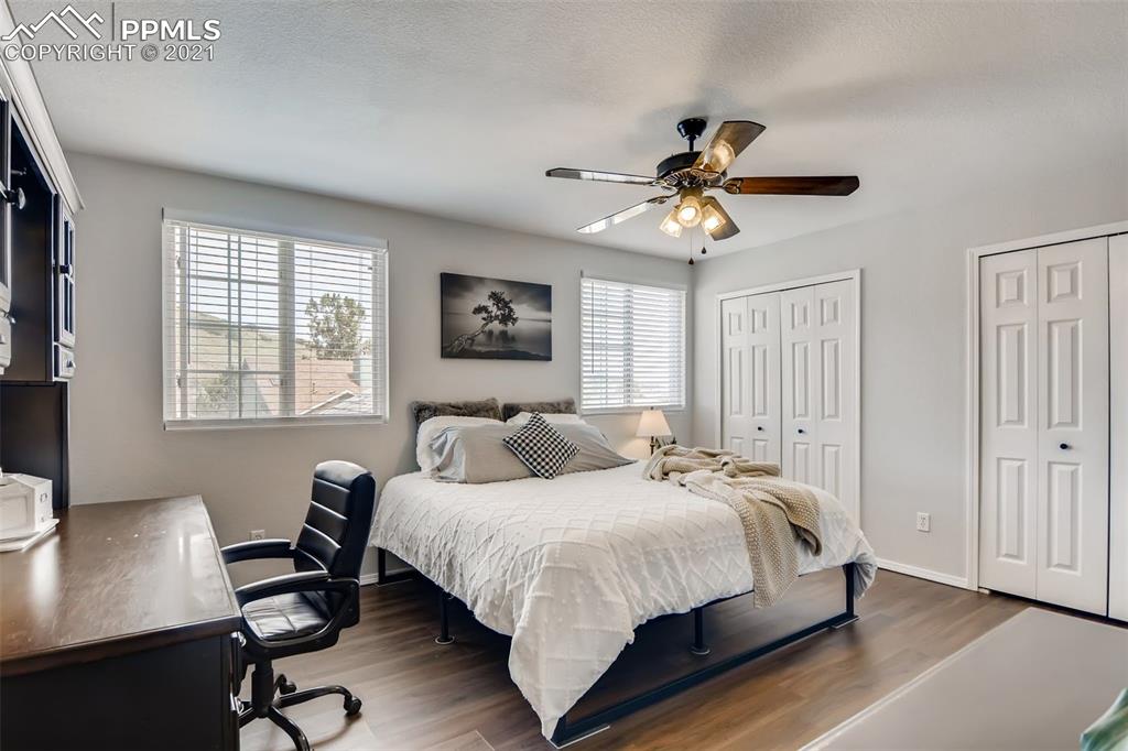 7330 Julynn Road Colorado Springs, CO 80919 - Photo 13 of 28 a bedroom with a bed and a desk