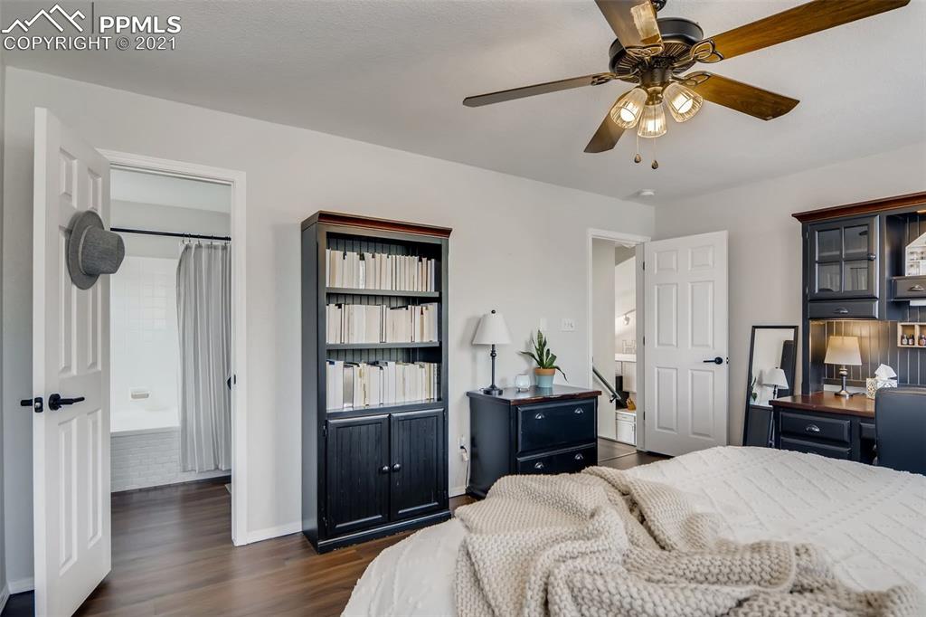 7330 Julynn Road Colorado Springs, CO 80919 - Photo 15 of 28 a bedroom with a bed and a tv
