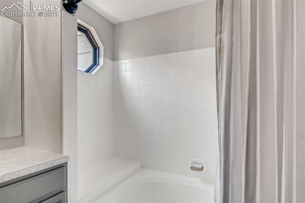 7330 Julynn Road Colorado Springs, CO 80919 - Photo 18 of 28 a bathroom with a shower and a sink