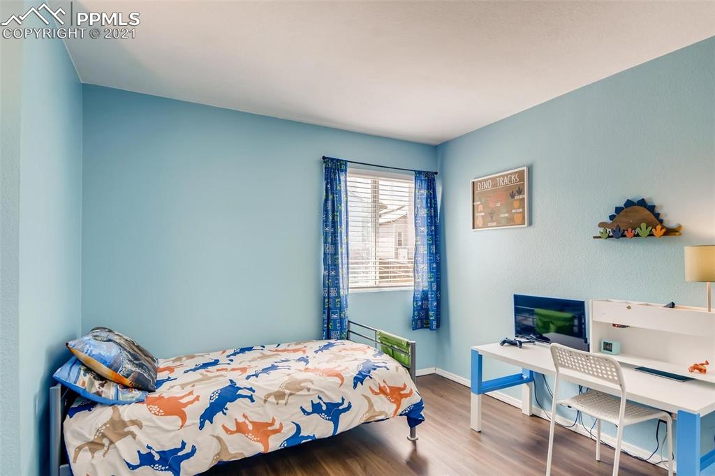 7330 Julynn Road Colorado Springs, CO 80919 - Photo 19 of 28 a bedroom with a bed and a window