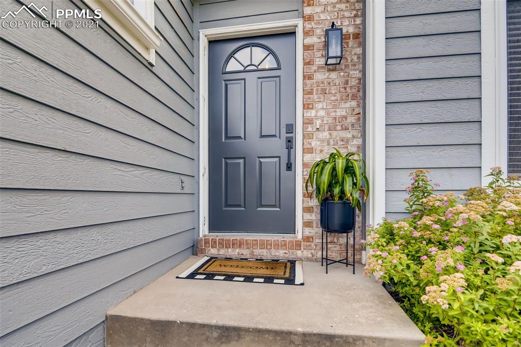 7330 Julynn Road Colorado Springs, CO 80919 - Photo 3 of 28 a front view of a house with a garden