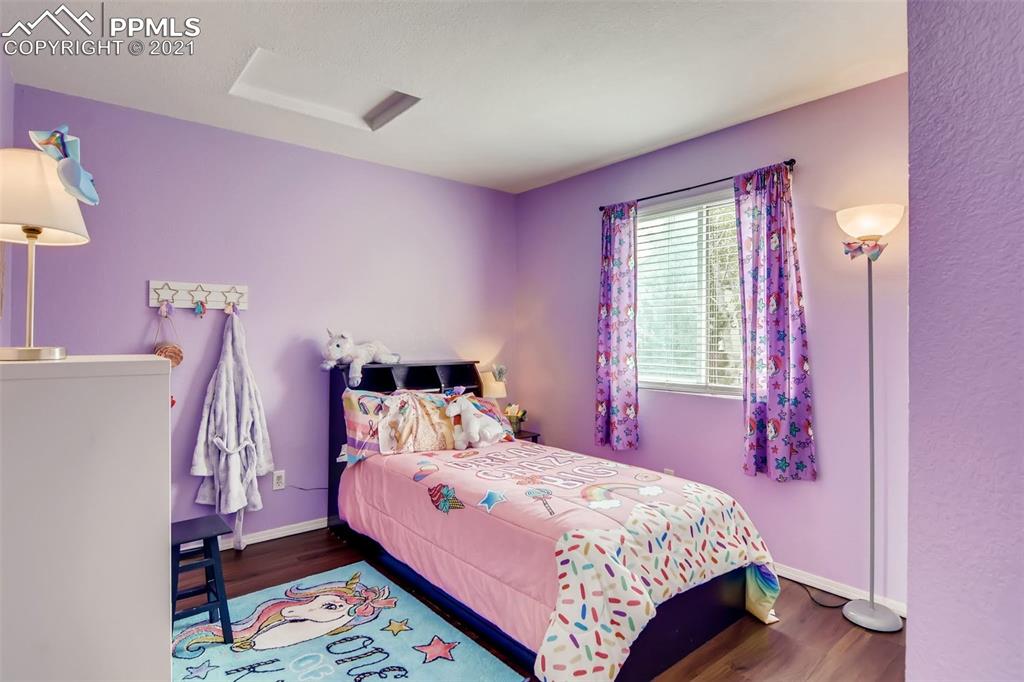 7330 Julynn Road Colorado Springs, CO 80919 - Photo 21 of 28 a bedroom with a bed and a window