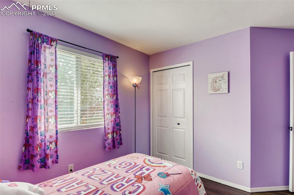 7330 Julynn Road Colorado Springs, CO 80919 - Photo 22 of 28 a bedroom with a bed and a window