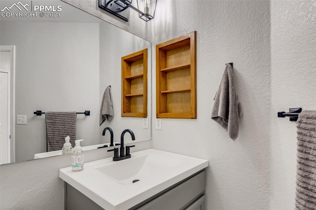 7330 Julynn Road Colorado Springs, CO 80919 - Photo 23 of 28 a bathroom with a sink and a mirror