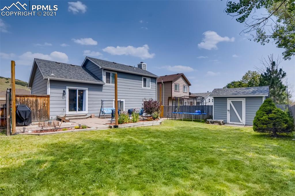 7330 Julynn Road Colorado Springs, CO 80919 - Photo 26 of 28 a house view with a sitting space and garden