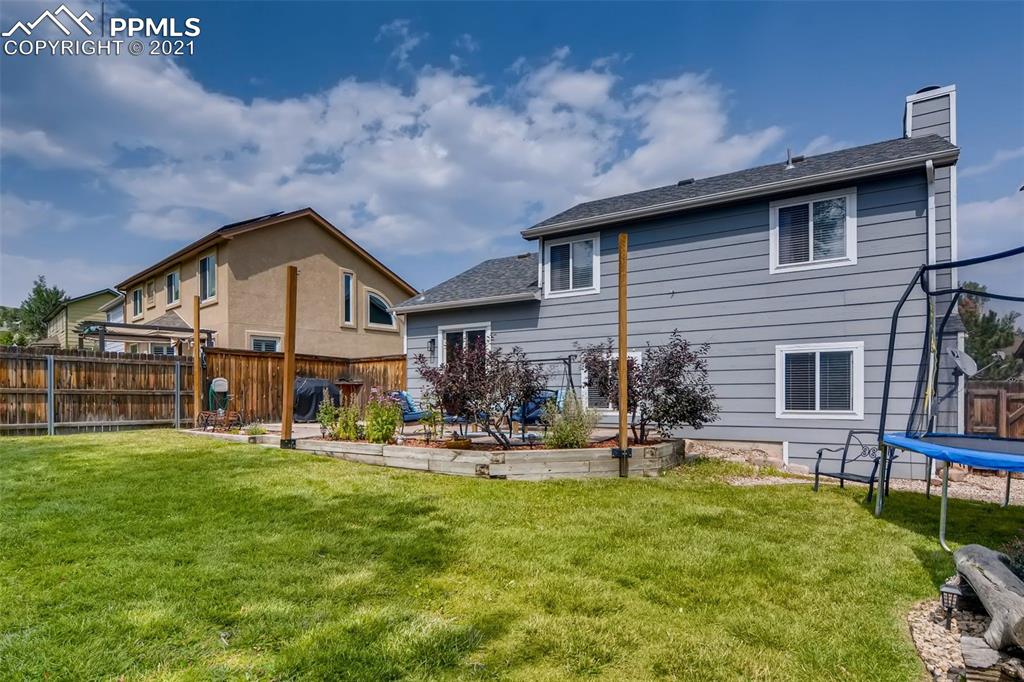 7330 Julynn Road Colorado Springs, CO 80919 - Photo 27 of 28 a view of a house with a yard and sitting area