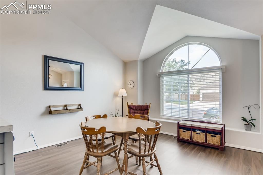 7330 Julynn Road Colorado Springs, CO 80919 - Photo 4 of 28 a dining room with furniture and wooden floor
