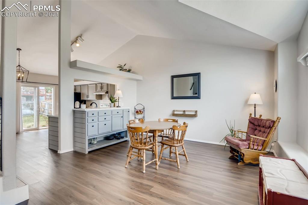 7330 Julynn Road Colorado Springs, CO 80919 - Photo 5 of 28 a dining room with furniture and wooden floor