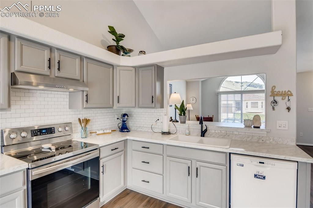 7330 Julynn Road Colorado Springs, CO 80919 - Photo 8 of 28 a kitchen with stainless steel appliances granite countertop a sink a stove and cabinets