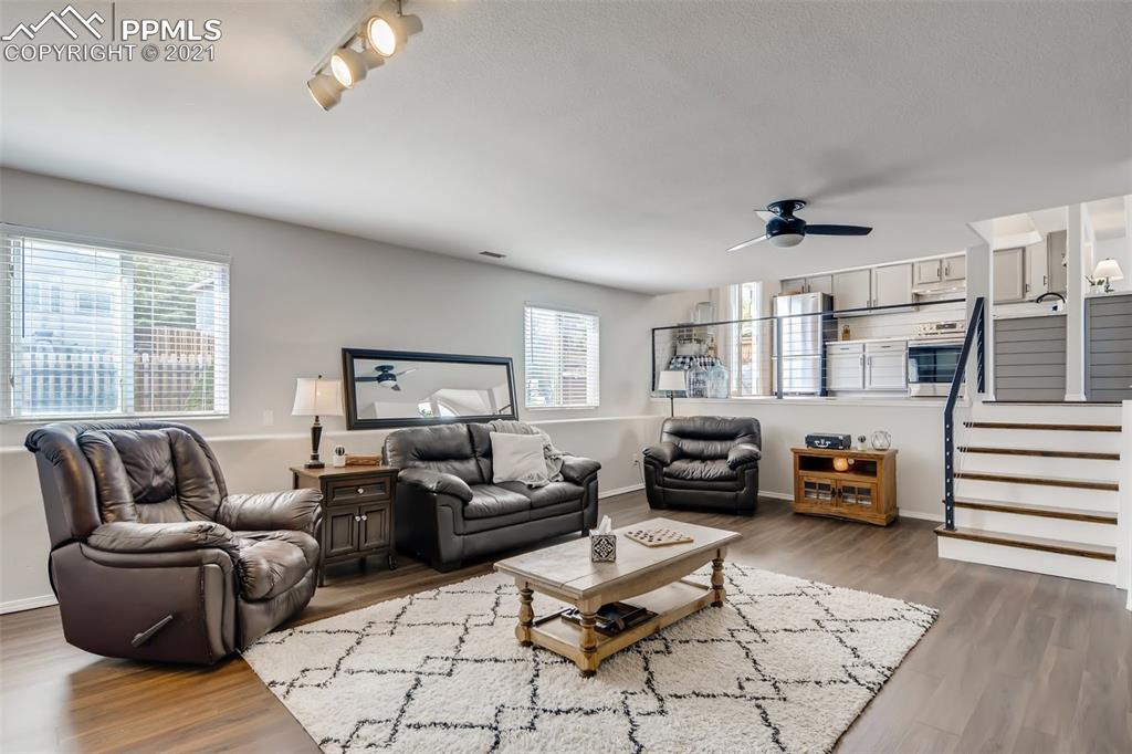 7330 Julynn Road Colorado Springs, CO 80919 - Photo 10 of 28 a living room with furniture and wooden floor
