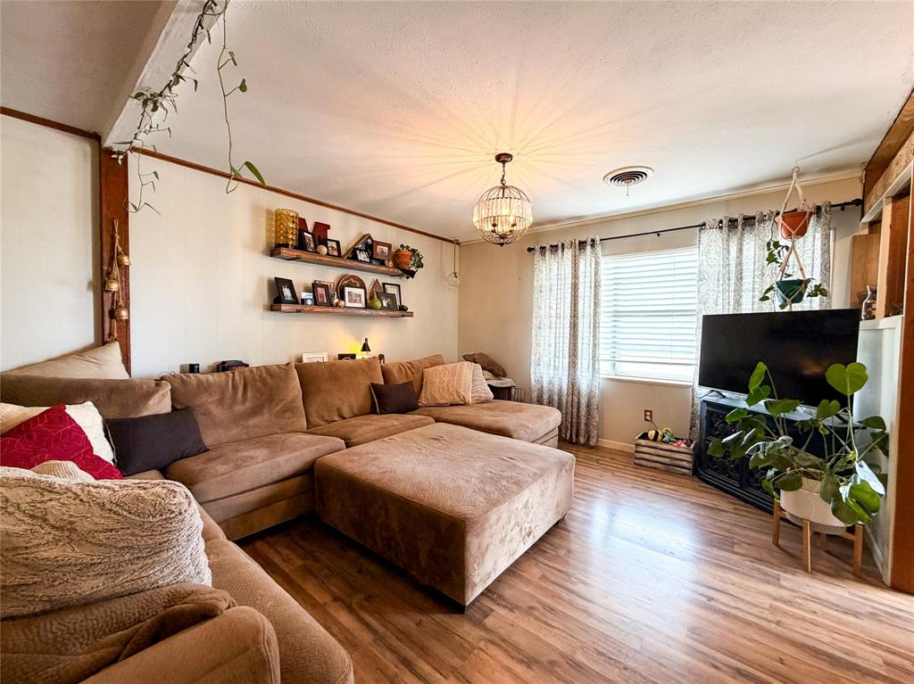 1706 North Ave H Haskell, TX 79521 - Photo 7 of 25 a living room with furniture flat screen tv and wooden floor